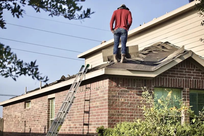 Professional roofer working on a residential roof in Naughright